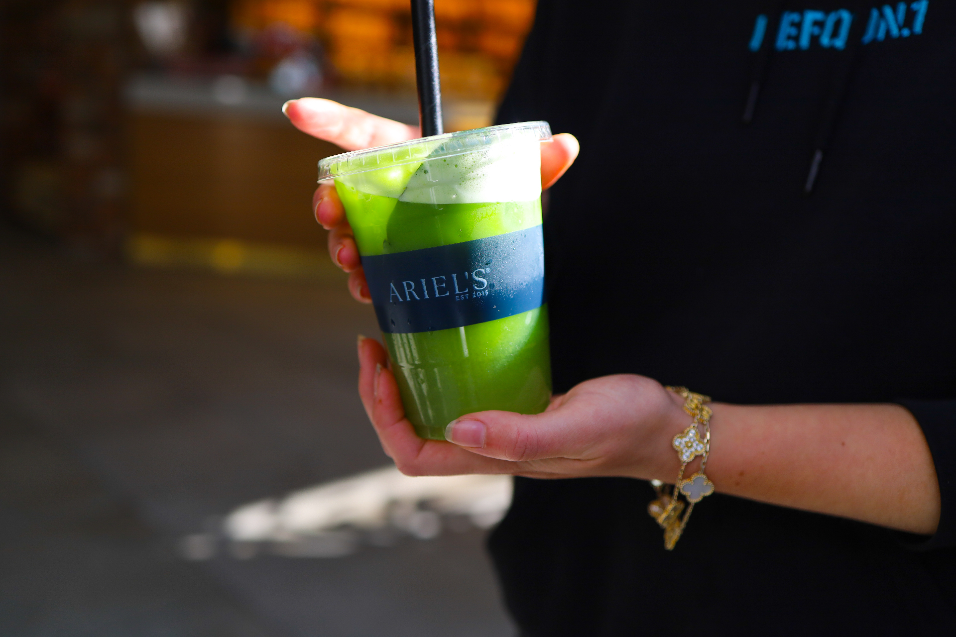 Fresh green juice in an Ariel's branded cup