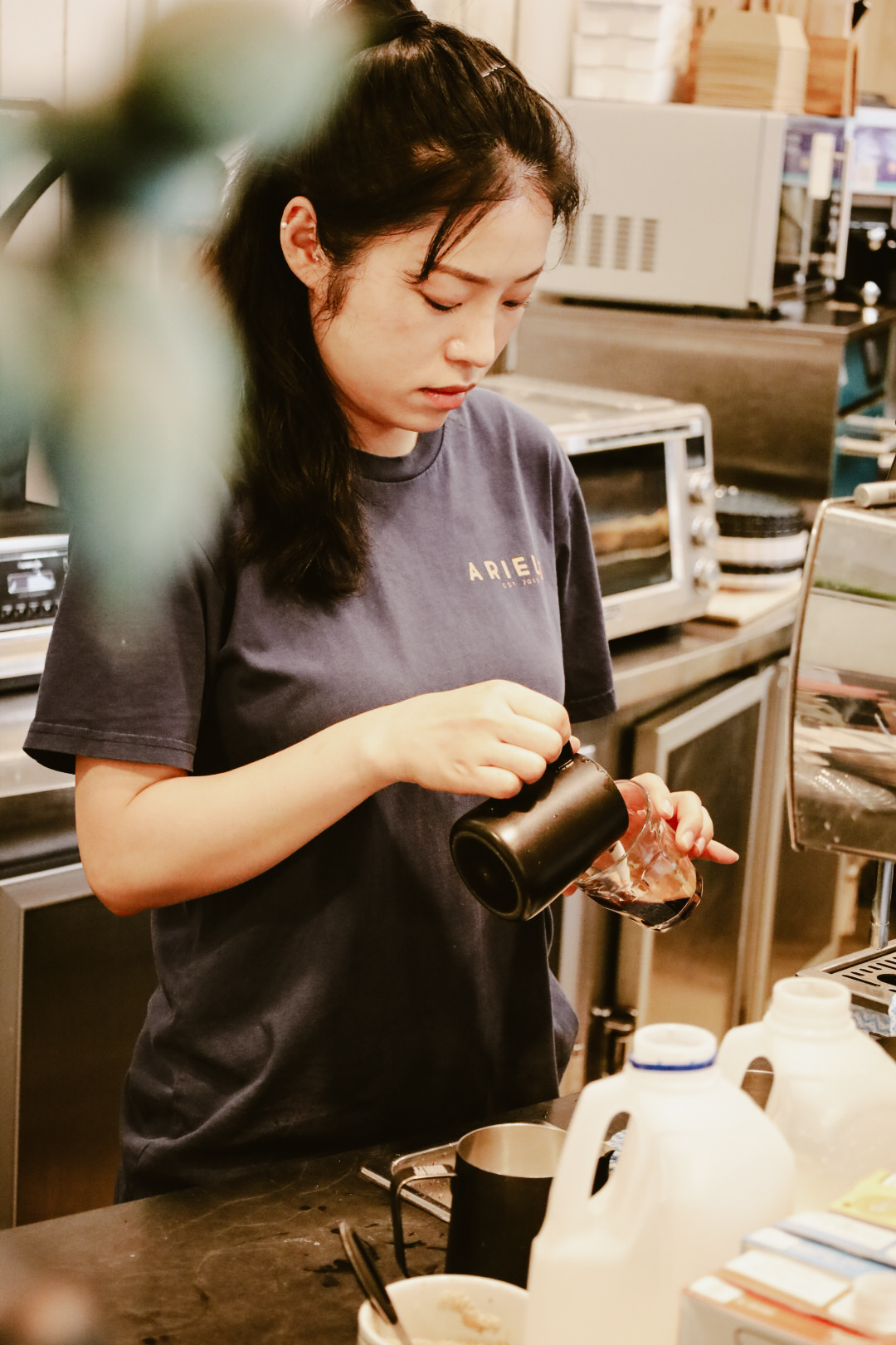 Ariel's barista crafting a coffee