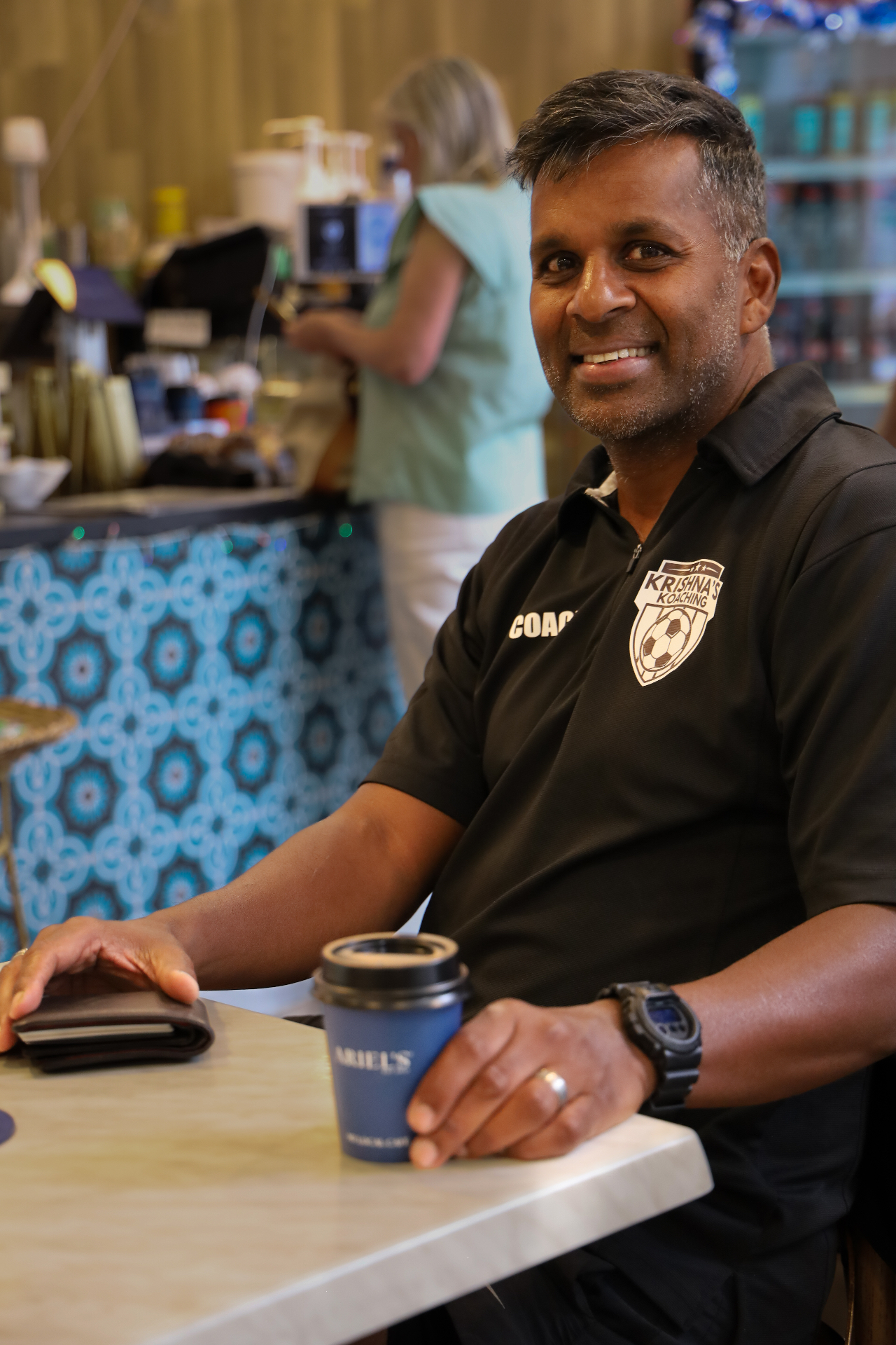 Customer enjoying coffee at Ariel's