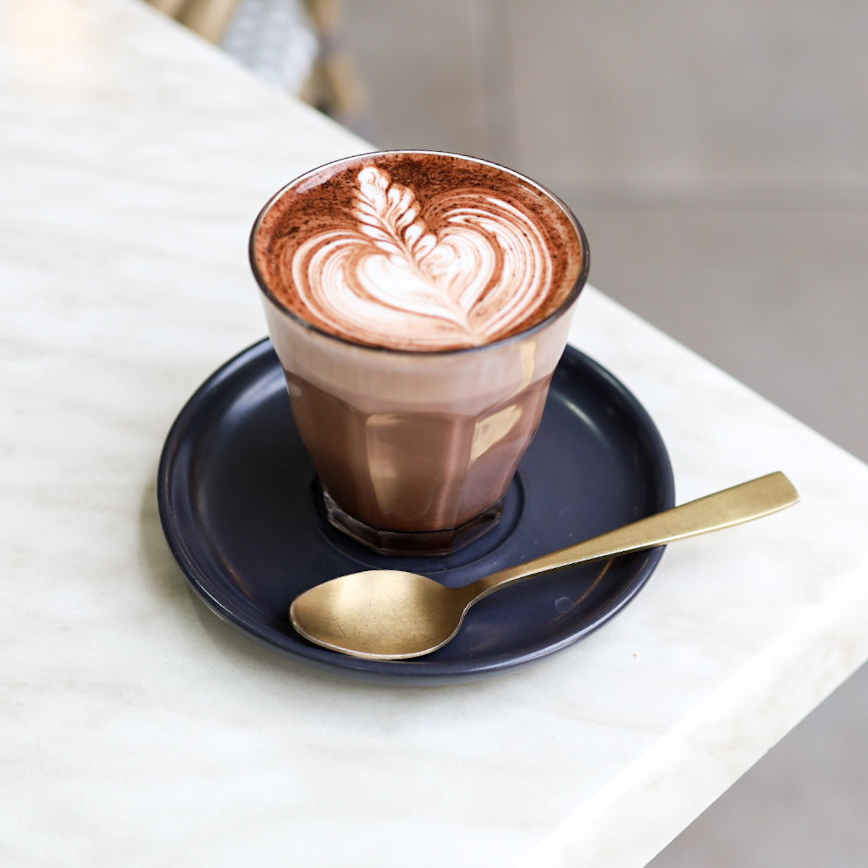 Mocha in a glass with cocoa-dusted latte art
