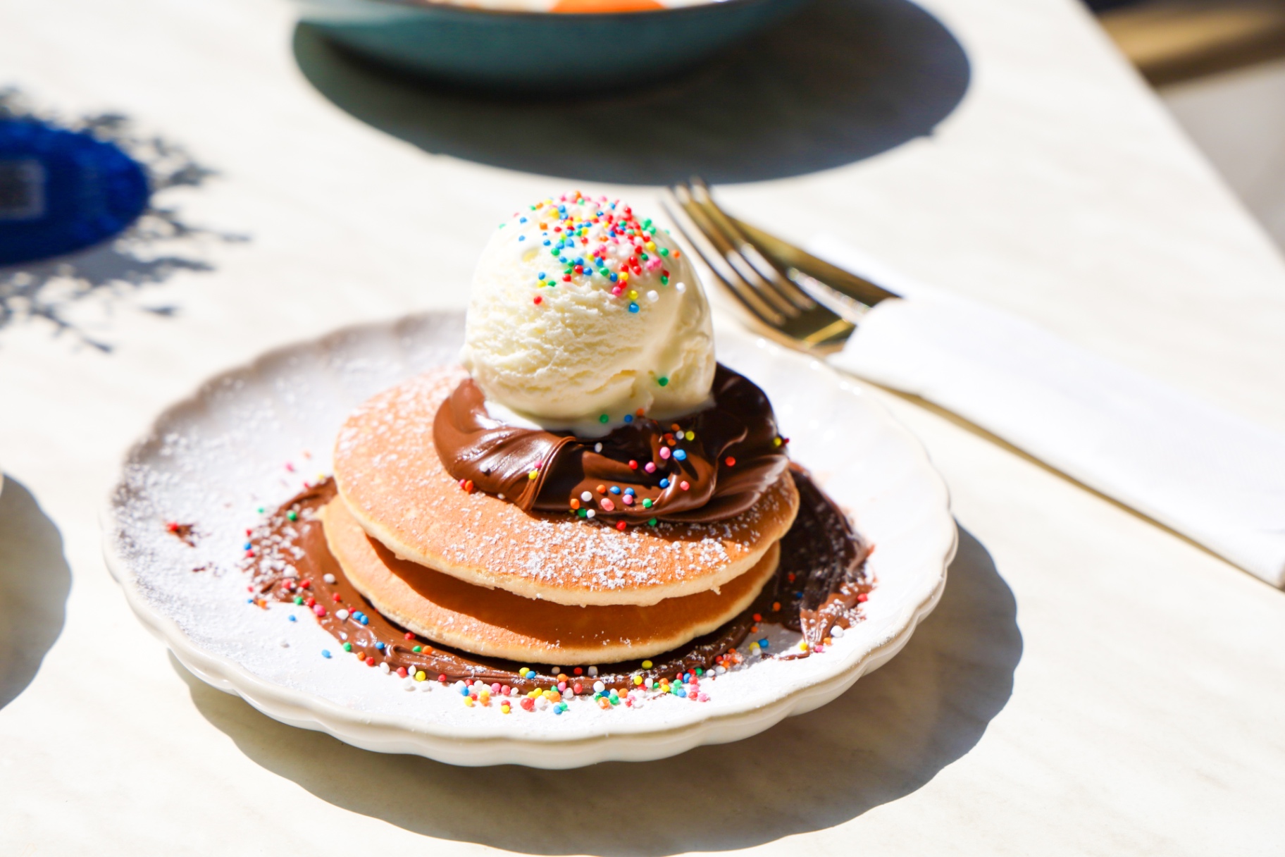 Kids pancakes with ice cream, Nutella and sprinkles