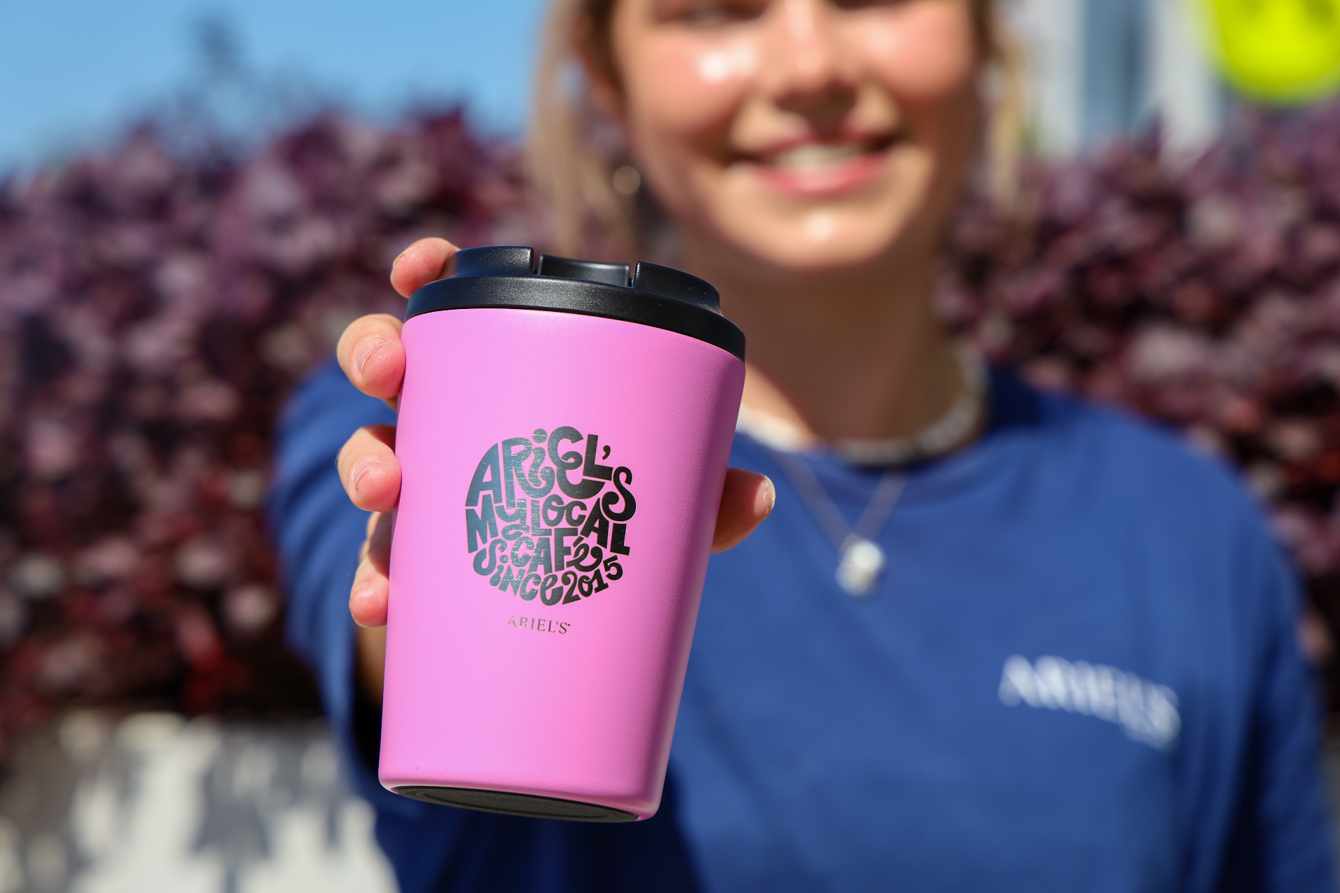 Ariel's barista holding a limited-edition pink Ariel's Keep Cup
