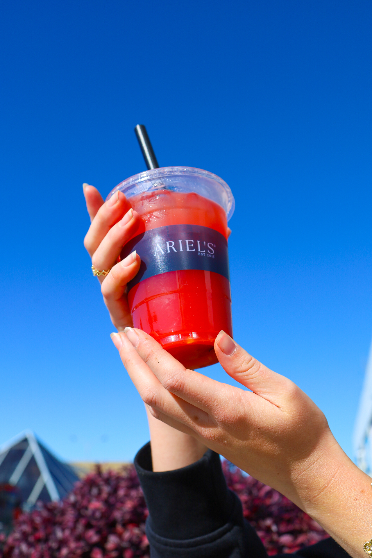 Strawberry iced drink in an Ariel's cup against blue sky