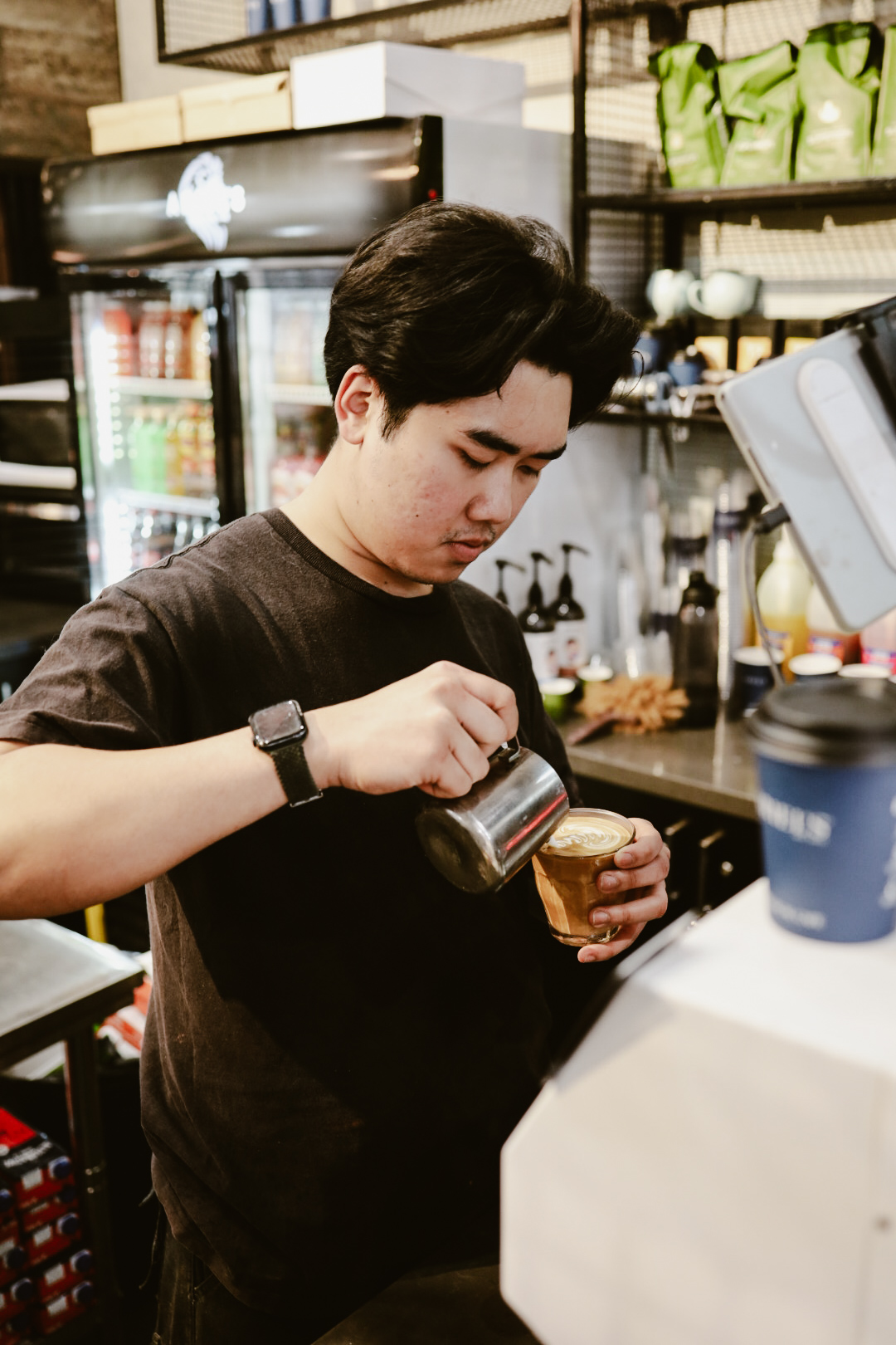 Barista finishing latte art during service