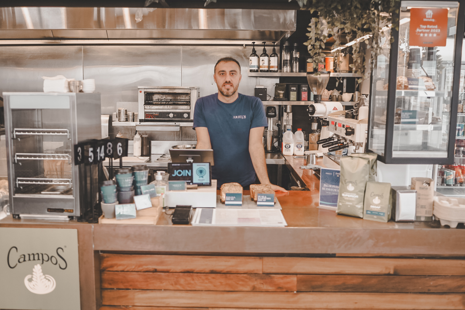 Barista working at Ariel's sleek counter