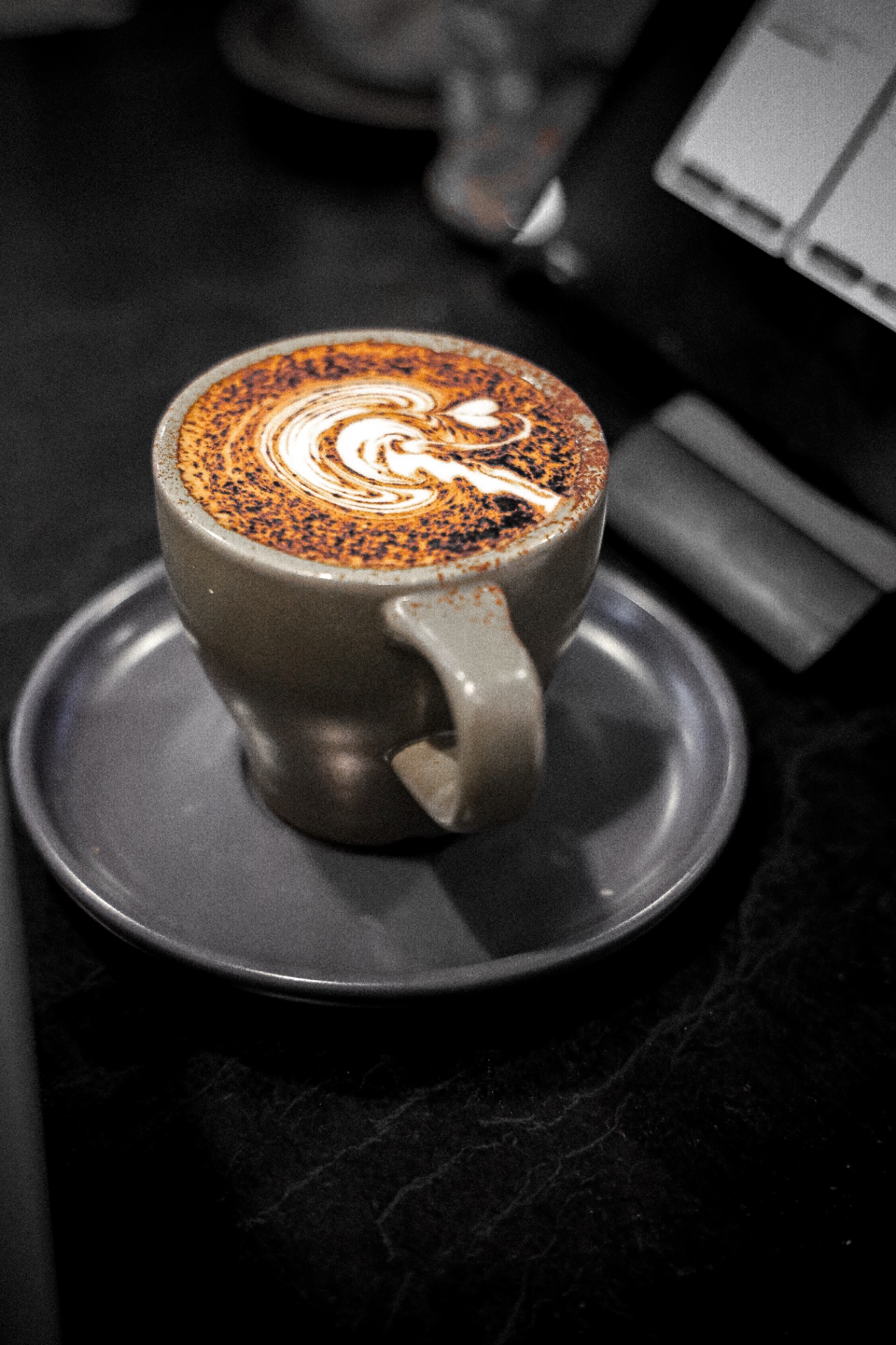 Cappuccino with chocolate dusted latte art at Ariel's