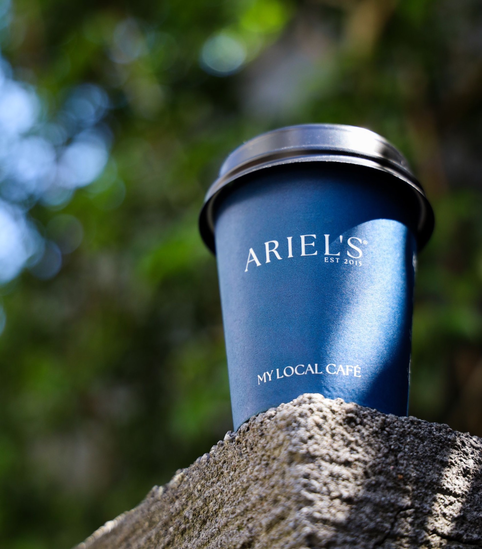Barista pouring latte art at Ariel's